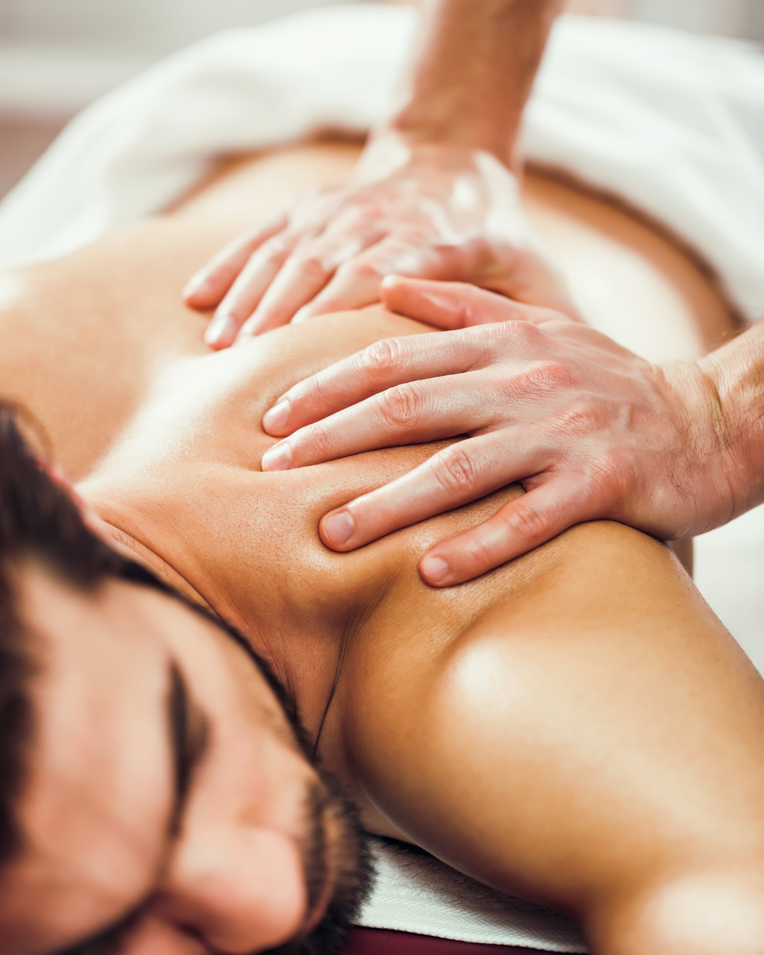 Man receiving massage to help him work out a muscle knot at Bella Sante spa in Boston Lexington and Wellesley