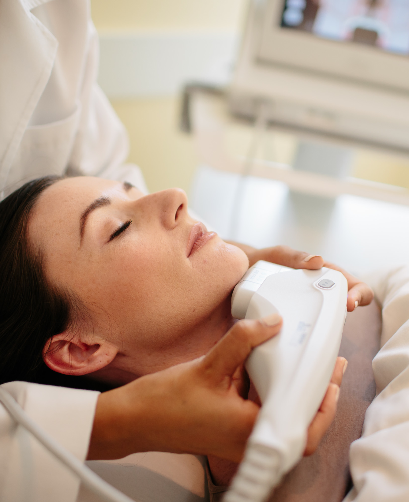 Woman receiving laser facial treatment in Boston.