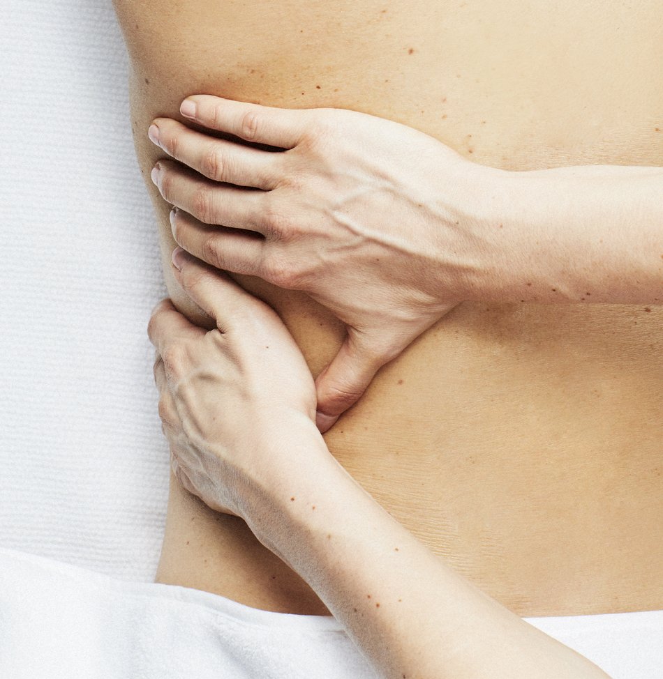Two hands on a back giving a deep tissue massage in Boston, Lexington and Wellesley