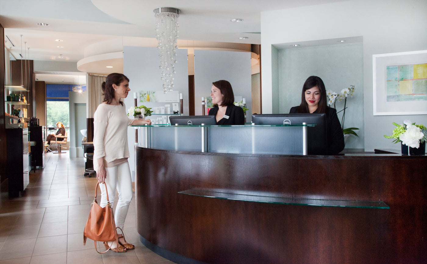 Woman inquiring about spa services in Wellesley at Bella  Santé.