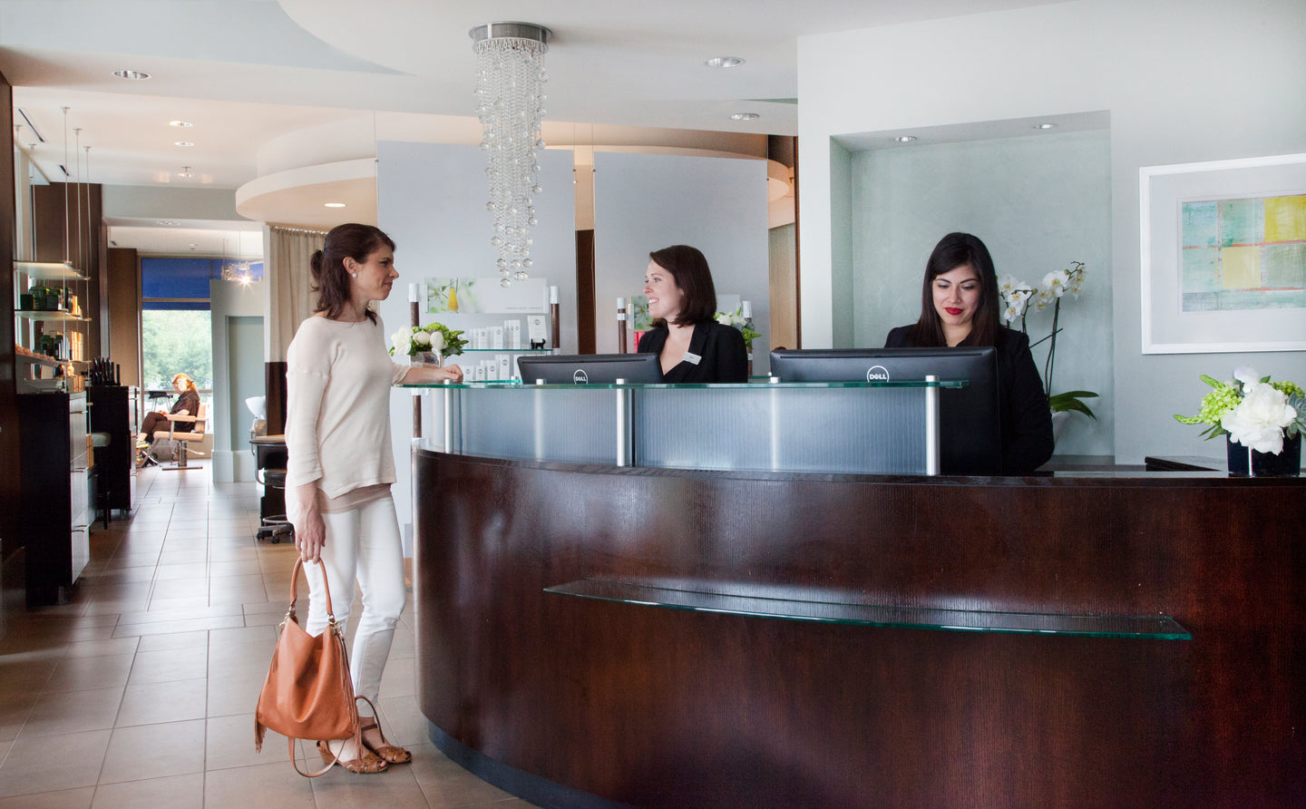 Woman inquiring about spa services in Wellesley at Bella  Santé.