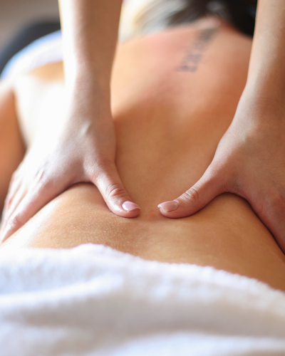 Relaxed woman receiving a professional massage at a luxury spa, promoting stress relief and wellness