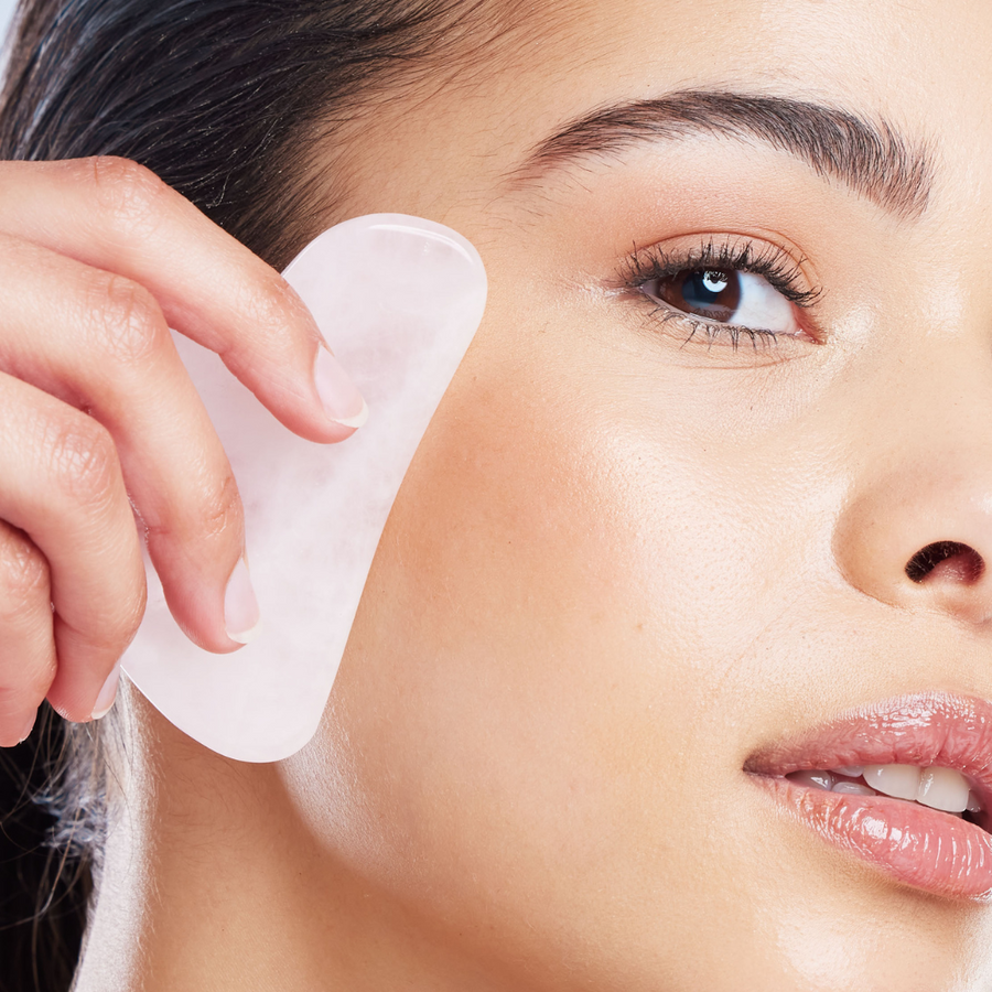 Woman Using Gua Sha Stone For Face