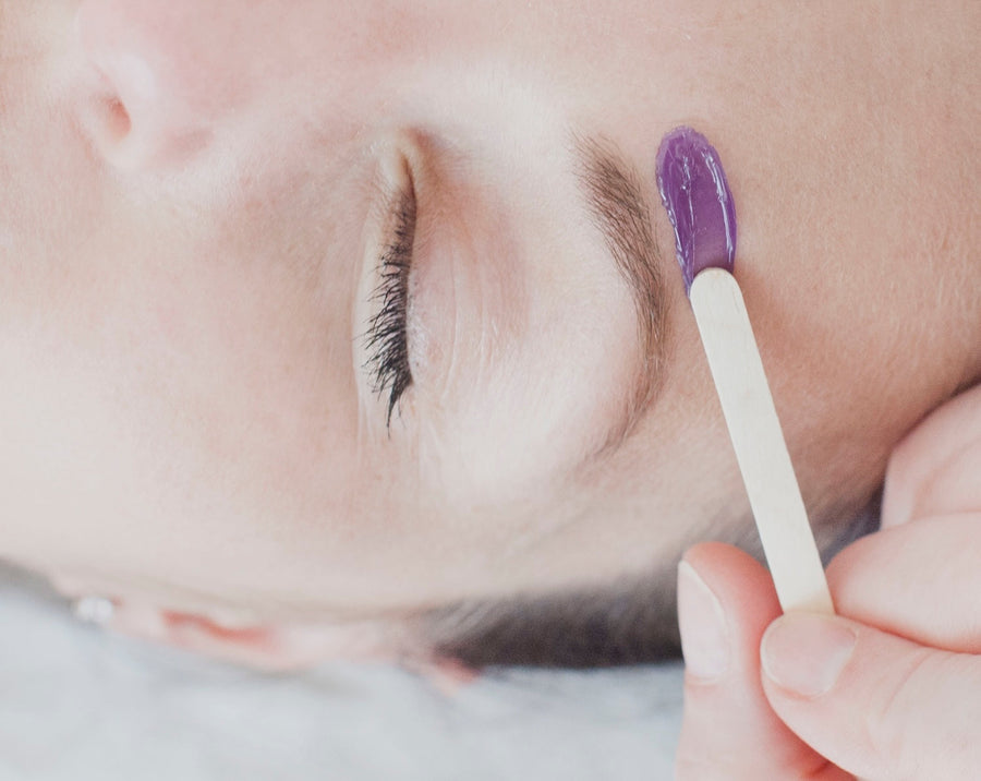 woman receiving a skin waxing treatment