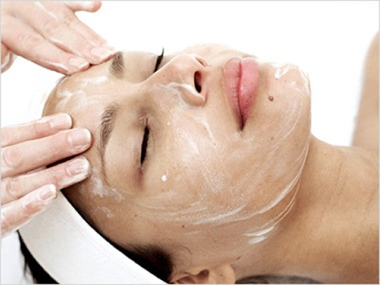 Relaxed woman receiving a professional facial treatment at Bella Santé spa, enjoying a luxurious and rejuvenating skincare experience