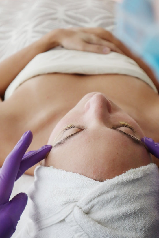 Woman receiving a professional chemical peel facial treatment at Bella Santé Med Spa