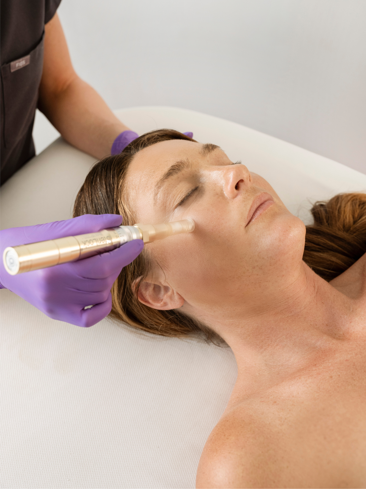 A guest receiving nano infusion facial treatment at Bella Santé in the Boston area.