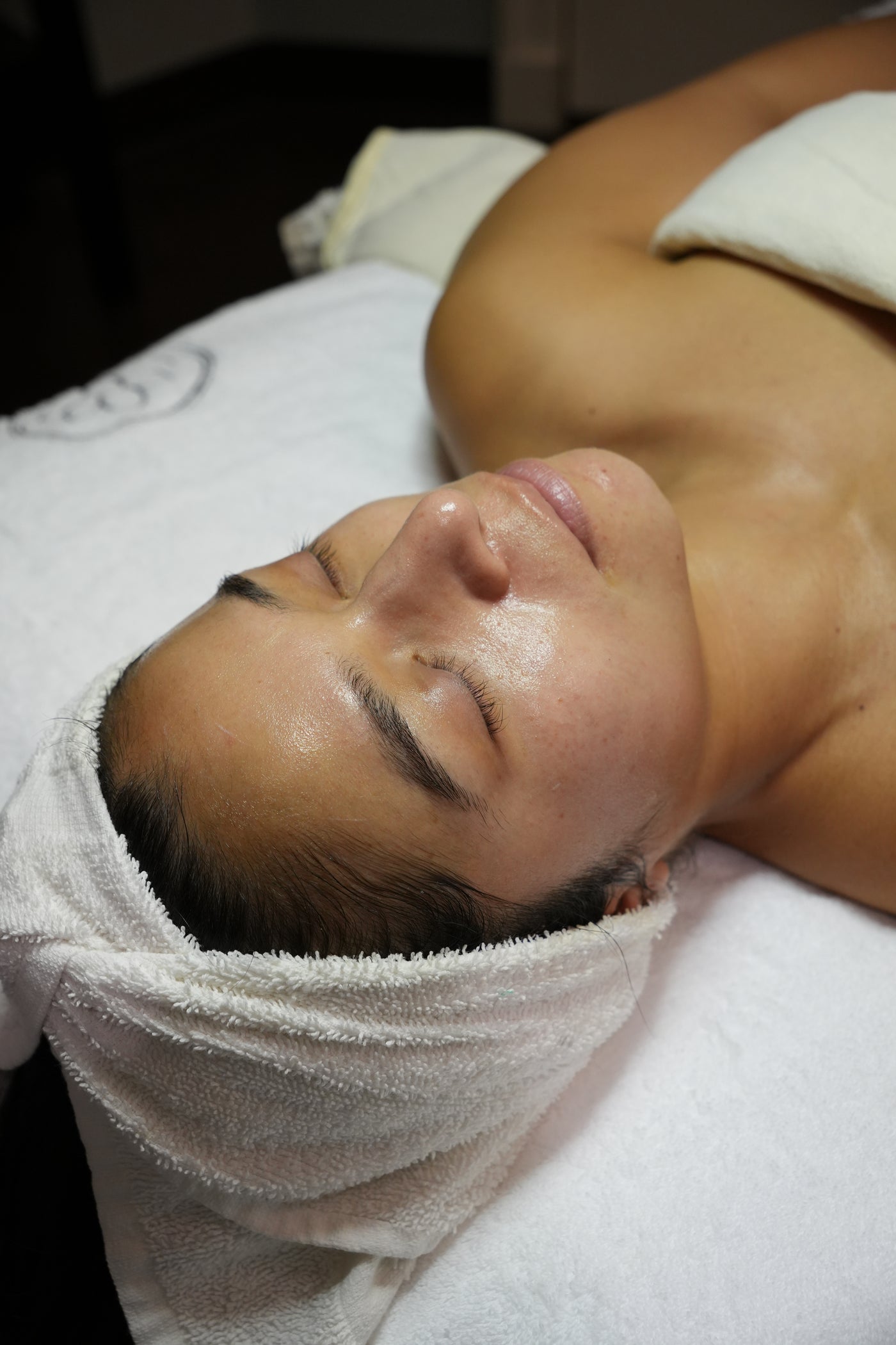 Guest receiving a PRX facial with a towel on their head in a spa setting at Bella Sante in Boston