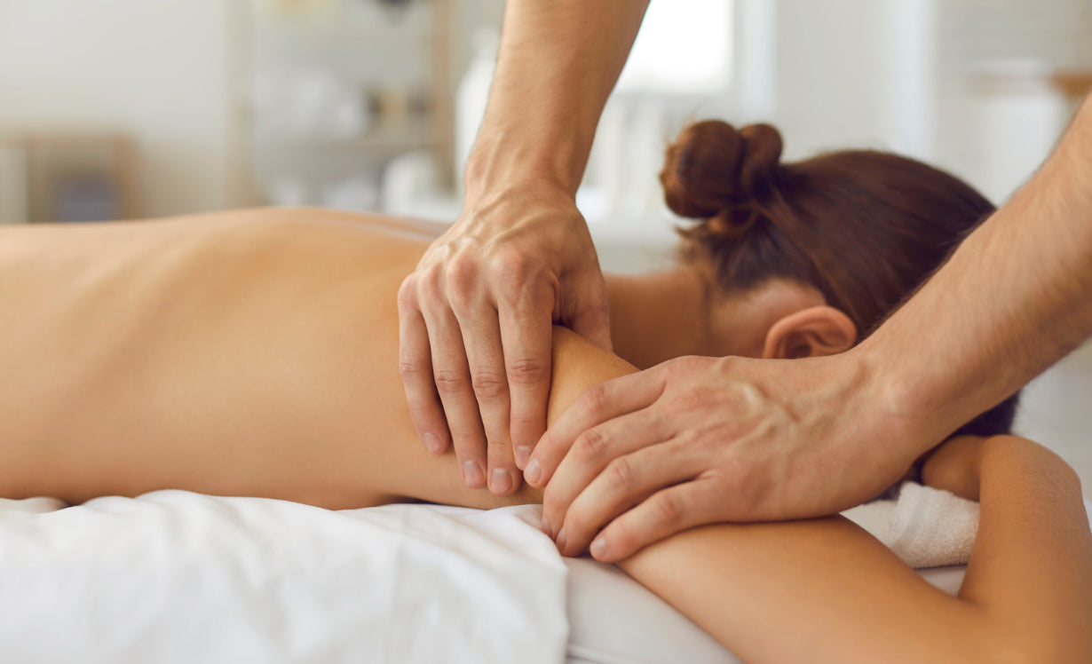 Image of a woman on a table receiving a body treatment. Click on link to go to navigate to the Best of Boston med spa treatment menu.